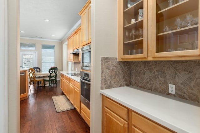 kitchen featuring dark wood-style floors, decorative backsplash, glass insert cabinets, appliances with stainless steel finishes, and crown molding