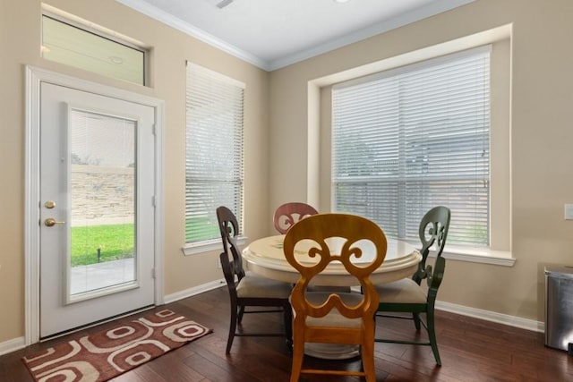 dining room featuring baseboards, dark wood-type flooring, and crown molding