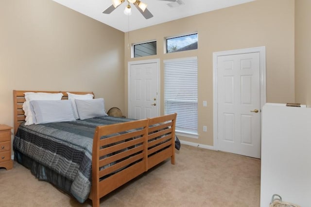 bedroom featuring a ceiling fan, light colored carpet, visible vents, and baseboards