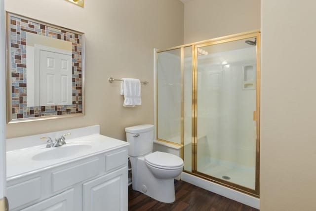 full bathroom with vanity, toilet, wood finished floors, and a shower stall