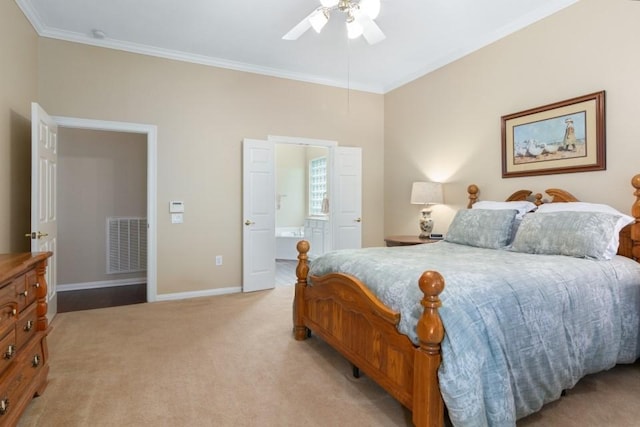 bedroom featuring visible vents, crown molding, baseboards, light colored carpet, and ensuite bathroom