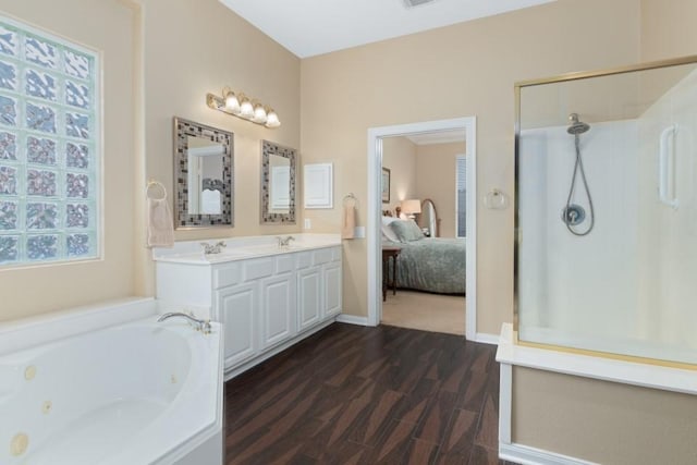 full bathroom with a walk in shower, a whirlpool tub, wood finished floors, ensuite bath, and a sink