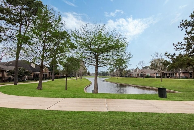 view of community featuring a yard and a water view