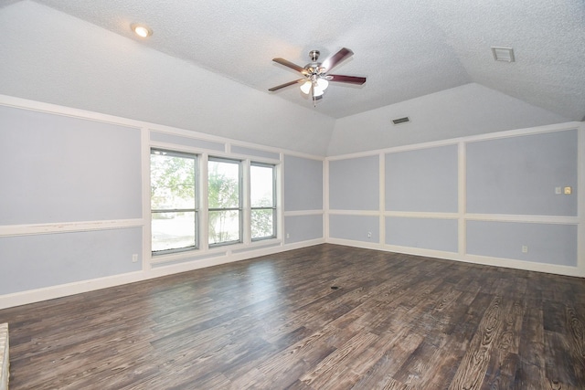 unfurnished room with wood finished floors, lofted ceiling, a textured ceiling, and ceiling fan