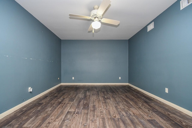 spare room with baseboards, wood finished floors, visible vents, and ceiling fan