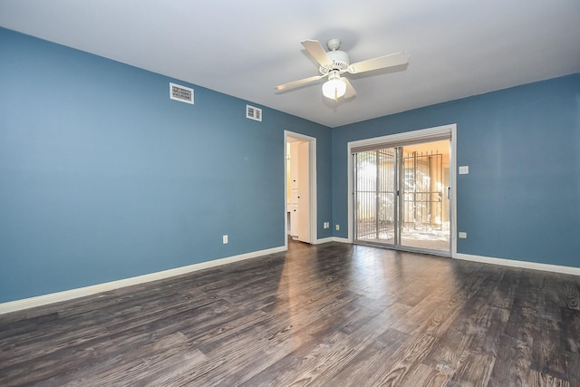 unfurnished room with dark wood finished floors, visible vents, baseboards, and a ceiling fan