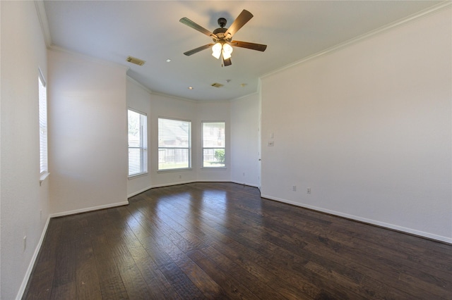 empty room featuring visible vents, crown molding, baseboards, ceiling fan, and dark wood-style floors