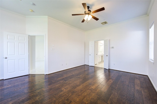 empty room featuring hardwood / wood-style floors, crown molding, a ceiling fan, and visible vents