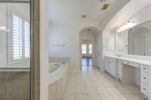 bathroom featuring visible vents, vanity, crown molding, and a garden tub