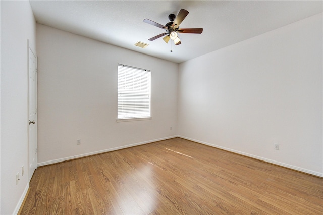 spare room with visible vents, baseboards, ceiling fan, and light wood finished floors