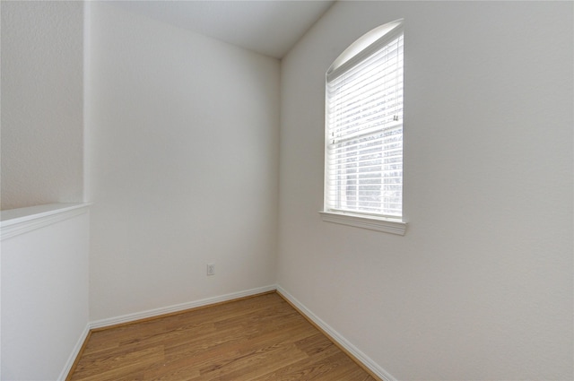 spare room with light wood-style flooring and baseboards