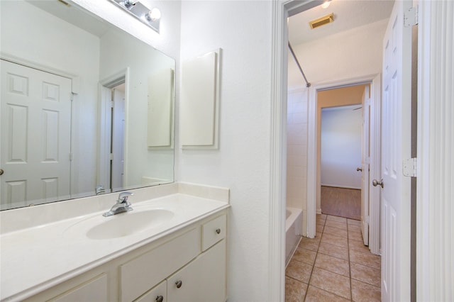 full bath with tile patterned flooring,  shower combination, vanity, and visible vents