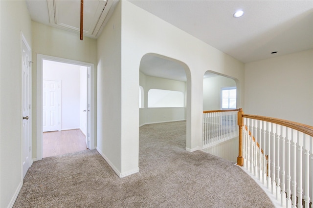 corridor featuring recessed lighting, attic access, baseboards, and carpet floors