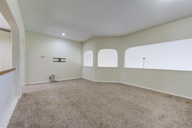 carpeted empty room featuring recessed lighting and baseboards