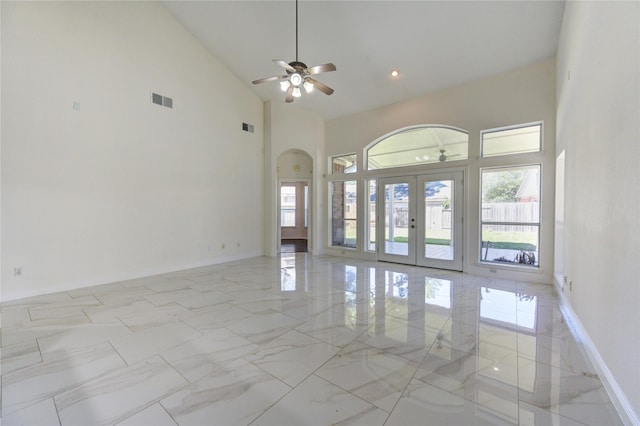 empty room with french doors, arched walkways, marble finish floor, and visible vents