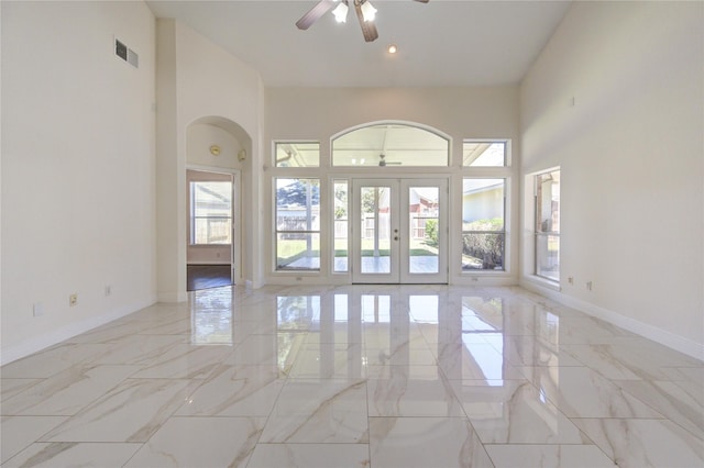 spare room featuring marble finish floor, a ceiling fan, visible vents, and french doors