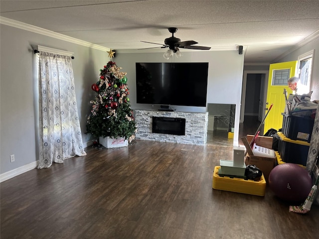 living room with a ceiling fan, crown molding, wood finished floors, and a wealth of natural light