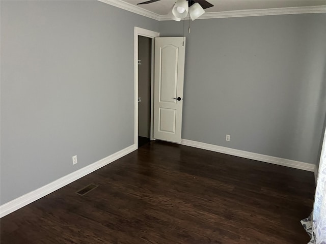 empty room featuring visible vents, a ceiling fan, crown molding, baseboards, and dark wood-style flooring