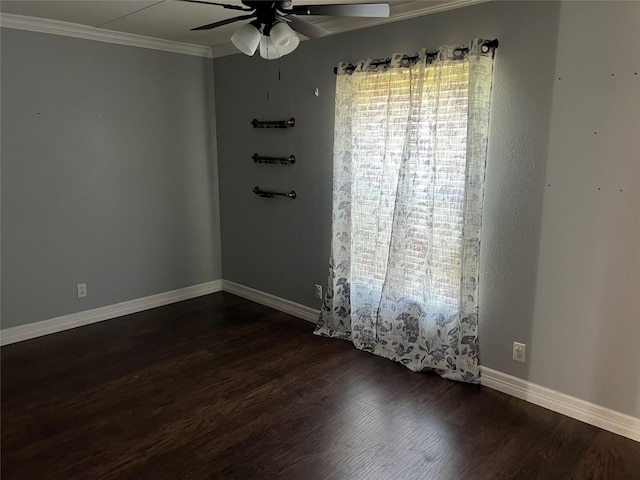 empty room with baseboards, crown molding, ceiling fan, and dark wood-style flooring