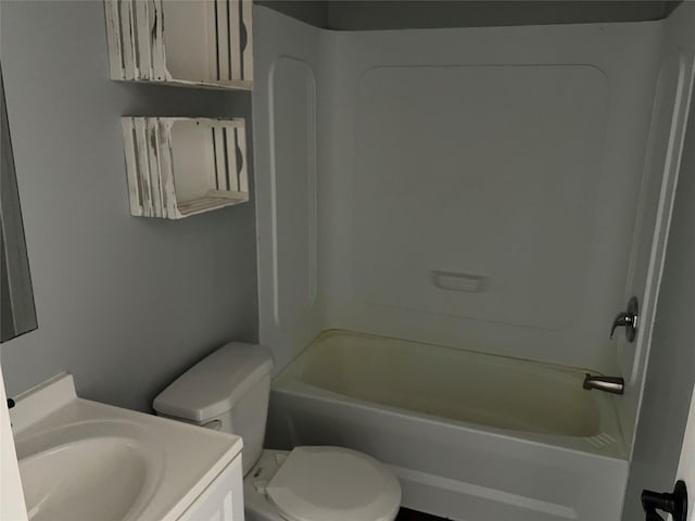 bathroom featuring vanity, toilet, and washtub / shower combination