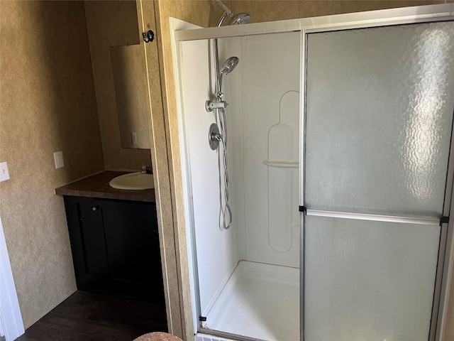 bathroom featuring a stall shower and vanity