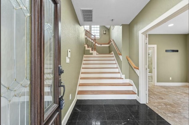 staircase with recessed lighting, visible vents, baseboards, and granite finish floor