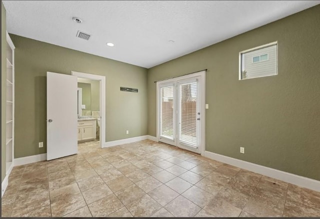 empty room with visible vents and baseboards