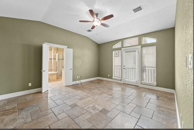 spare room featuring lofted ceiling, baseboards, and ceiling fan