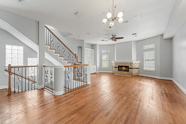6132 Maxie St, Houston, TX 77007 - unfurnished living room featuring a chandelier, wood finished floors, baseboards, a ceiling fan, and a multi sided fireplace