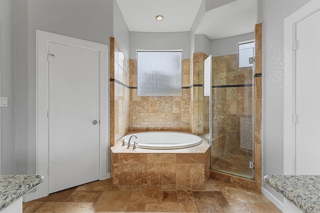 6132 Maxie St, Houston, TX 77007 - full bathroom with a garden tub, a stall shower, and stone tile flooring