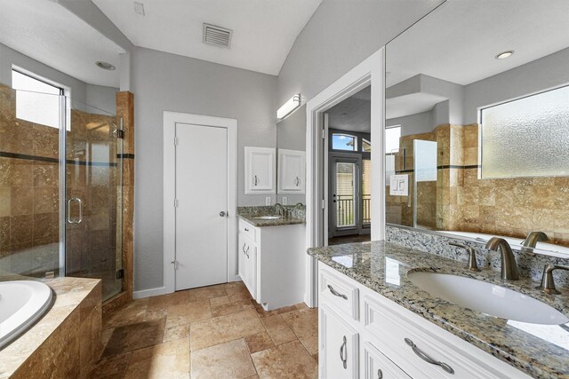6132 Maxie St, Houston, TX 77007 - full bath featuring a shower stall, stone tile floors, a bath, two vanities, and baseboards