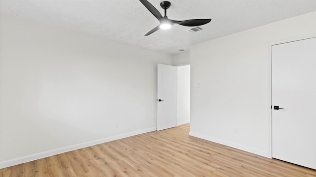 unfurnished bedroom with visible vents, a ceiling fan, a textured ceiling, light wood finished floors, and baseboards