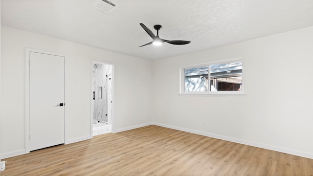 spare room with visible vents, baseboards, ceiling fan, and light wood finished floors