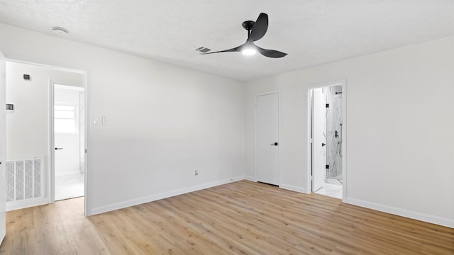 spare room with visible vents, a ceiling fan, a textured ceiling, light wood finished floors, and baseboards