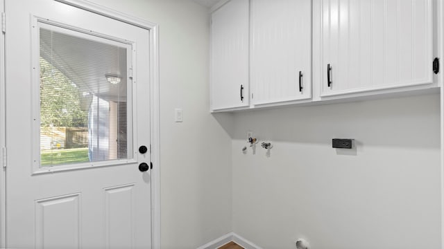 clothes washing area featuring washer hookup, cabinet space, baseboards, and electric dryer hookup