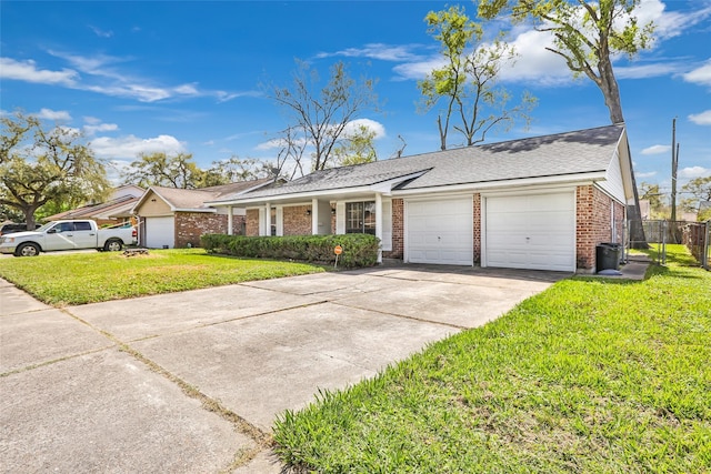 ranch-style home with brick siding, a front lawn, fence, concrete driveway, and an attached garage