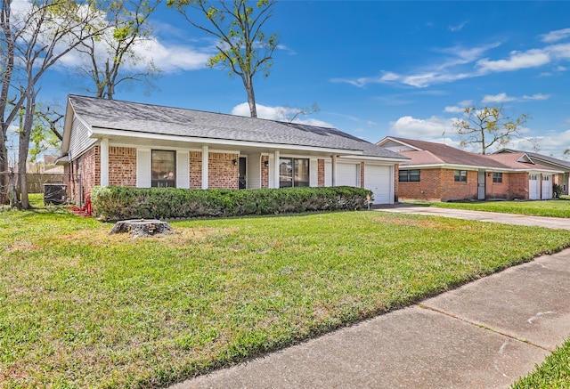 ranch-style home with a front lawn, brick siding, a garage, and driveway