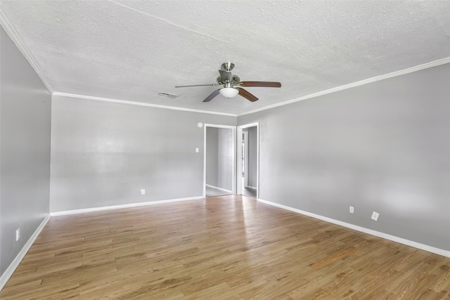 unfurnished room featuring crown molding, baseboards, light wood finished floors, and ceiling fan