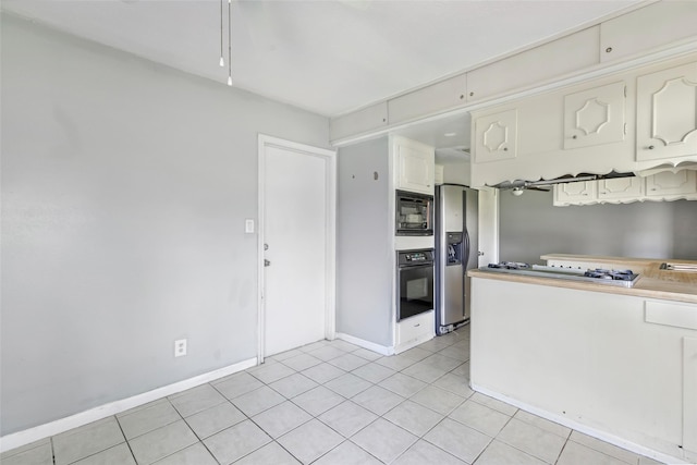 kitchen with black appliances, white cabinetry, light countertops, light tile patterned floors, and baseboards