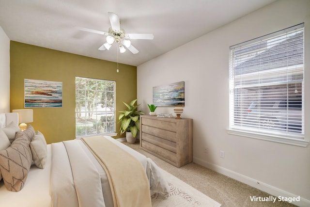 bedroom with baseboards, carpet, and a ceiling fan