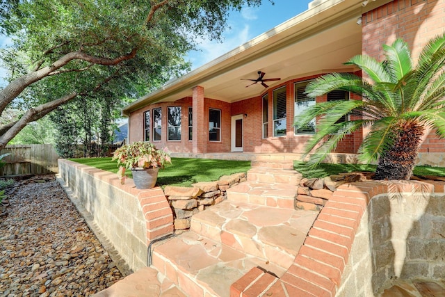 view of patio with a porch, a ceiling fan, and fence