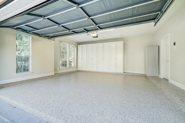 garage featuring a garage door opener and baseboards