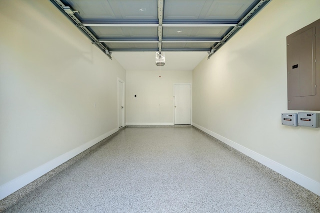 garage featuring electric panel, a garage door opener, and baseboards