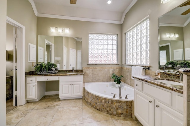 bathroom with crown molding, two vanities, a whirlpool tub, and a sink