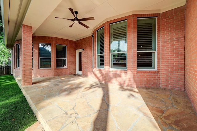 view of patio / terrace with a ceiling fan and fence