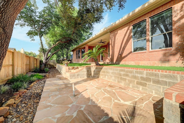 view of patio with a fenced backyard and ceiling fan