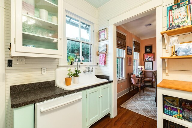 1411 13th St, Galveston, TX 77550 - bar with dishwasher, crown molding, dark wood-style flooring, and backsplash