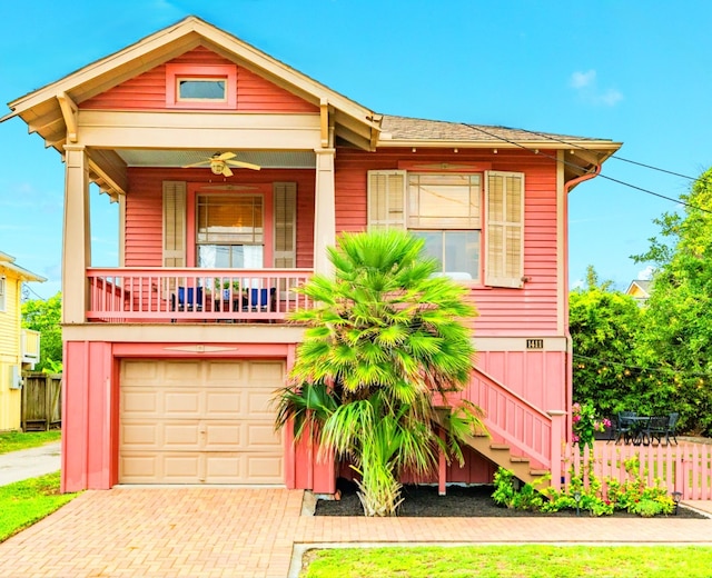 1411 13th St, Galveston, TX 77550 - view of front of home featuring decorative driveway, stairway, an attached garage, and a ceiling fan