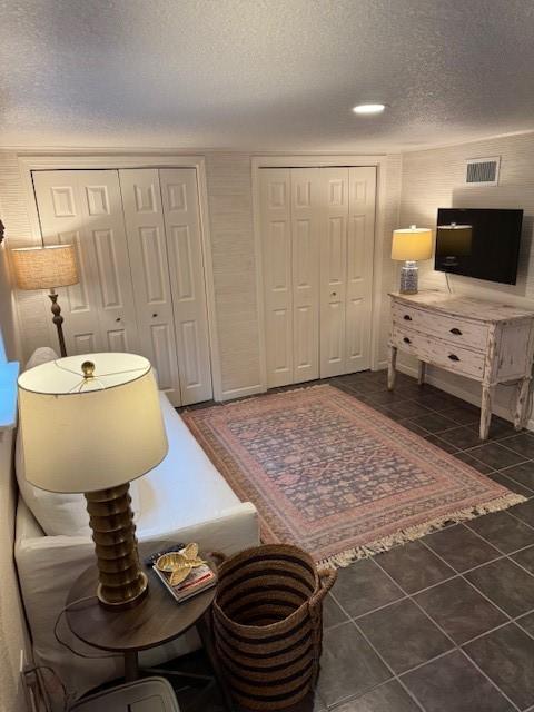 1411 13th St, Galveston, TX 77550 - living room featuring a textured ceiling and tile patterned floors