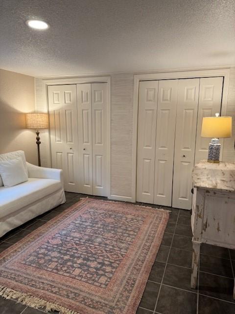 1411 13th St, Galveston, TX 77550 - living area featuring a textured ceiling, recessed lighting, and dark tile patterned floors